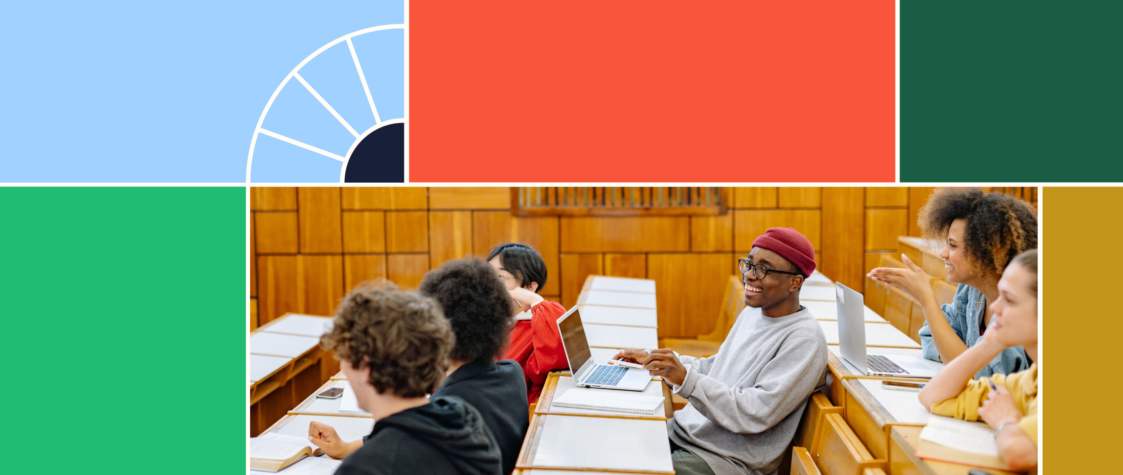 Two rows of students in a college lecture hall, two students are on computers and the group is smiling and laughing together 